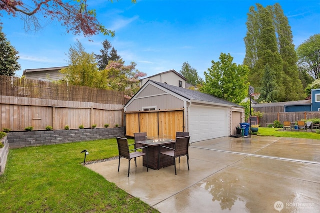 view of patio featuring outdoor dining space and a detached garage