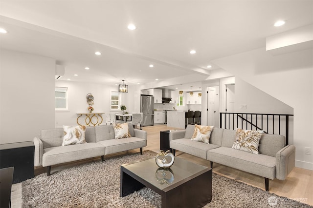 living area featuring light wood-style flooring and recessed lighting