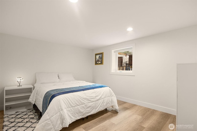 bedroom featuring wood finished floors, baseboards, and recessed lighting