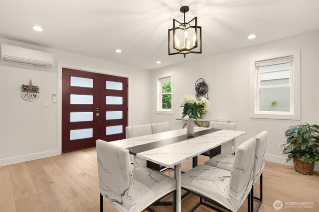 dining area with a wall mounted air conditioner, a chandelier, baseboards, light wood-type flooring, and recessed lighting