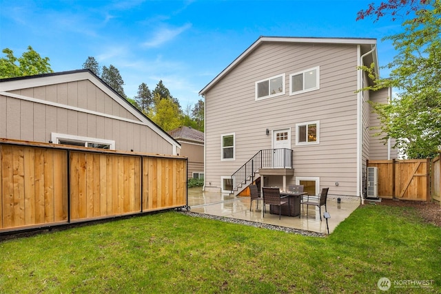 back of property with a patio area and a gate