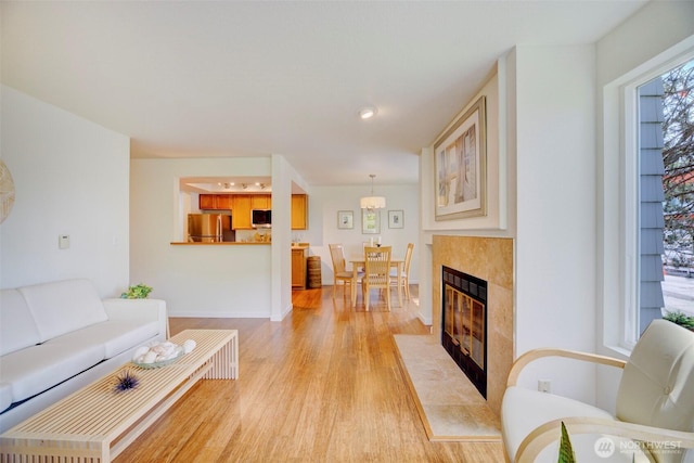 5901 Phinney Ave N Unit 103, Seattle, WA 98103 - living area with light wood-type flooring and a tile fireplace