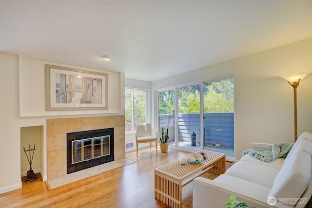 5901 Phinney Ave N Unit 103, Seattle, WA 98103 - living area with plenty of natural light, light wood-type flooring, and a tiled fireplace