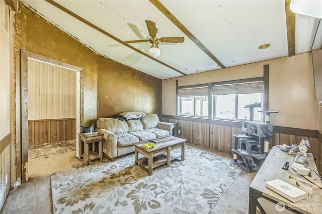 510 Duterrow Rd SE Unit 37, Olympia, WA 98513 - carpeted living area with wainscoting, a wood stove, ceiling fan, wooden walls, and vaulted ceiling