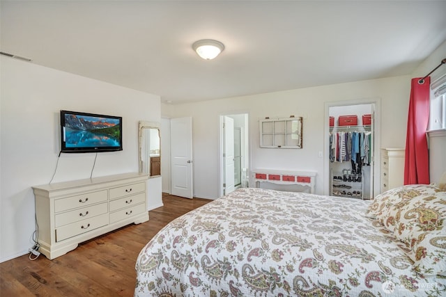 48 Bennett Ln, Oakville, WA 98568 - bedroom featuring dark wood-style floors, a spacious closet, a closet, ensuite bath, and baseboards