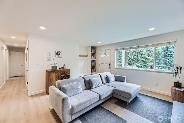 living area featuring light wood-style flooring, recessed lighting, and baseboards