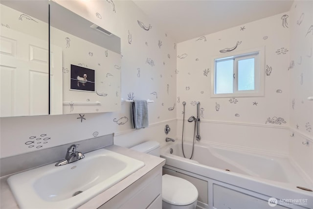 full bathroom featuring toilet, a tub to relax in, and vanity