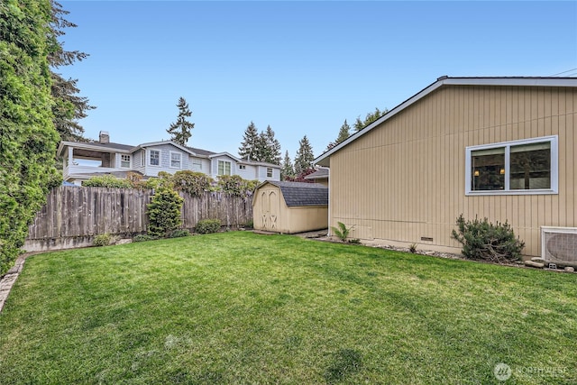 view of yard featuring a storage unit, an outbuilding, and ac unit