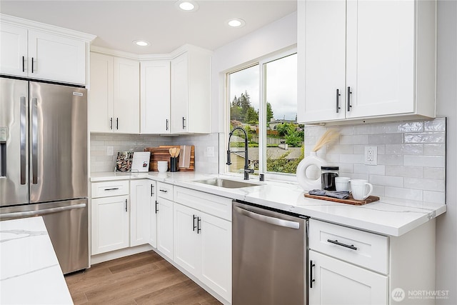 900 Sea Vista Pl, Edmonds, WA 98020 - kitchen with appliances with stainless steel finishes, a sink, recessed lighting, white cabinets, and light stone countertops