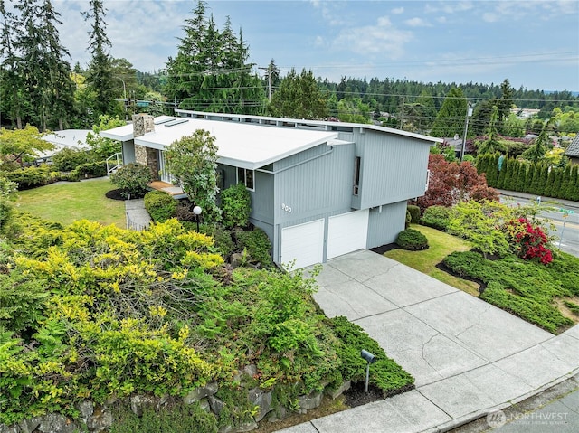 900 Sea Vista Pl, Edmonds, WA 98020 - view of front of home featuring an attached garage, concrete driveway, and a front lawn