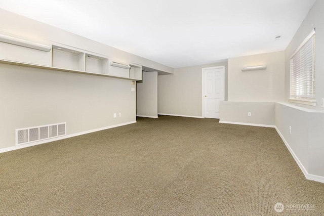 below grade area featuring dark colored carpet and baseboards