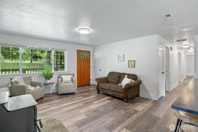 13520 Burn Rd, Arlington, WA 98223 - living room with wood finished floors, baseboards, and a textured ceiling