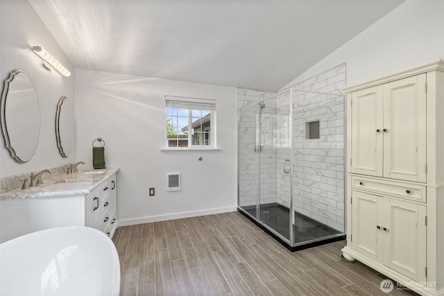 13520 Burn Rd, Arlington, WA 98223 - bathroom with lofted ceiling, wood finished floors, heating unit, a stall shower, and double vanity