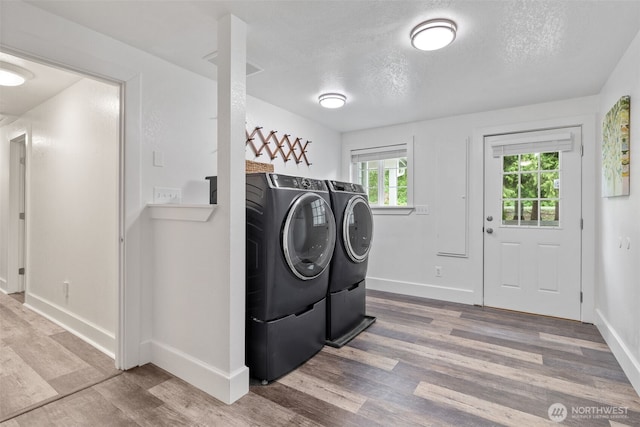 13520 Burn Rd, Arlington, WA 98223 - washroom with separate washer and dryer, wood finished floors, a textured ceiling, and baseboards