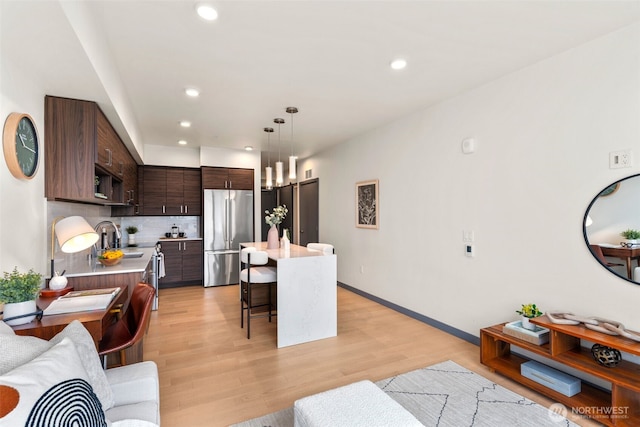 11903 NE 128th St Unit 612, Kirkland, WA 98034 - living area featuring recessed lighting, light wood-style flooring, and baseboards