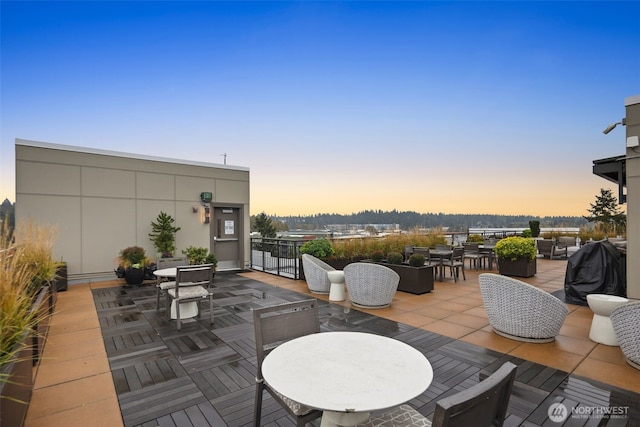 11903 NE 128th St Unit 612, Kirkland, WA 98034 - deck at dusk featuring outdoor dining area and a patio