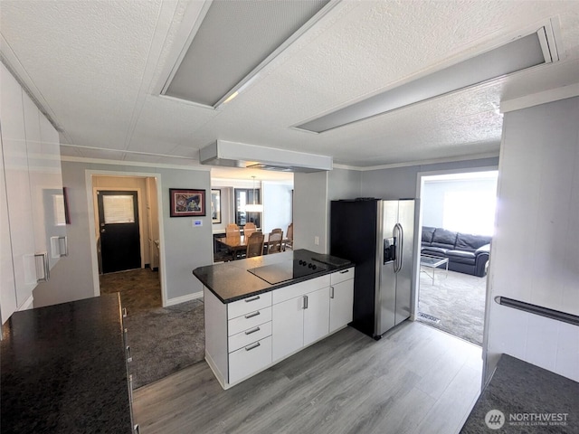 201 Union Ave SE Unit 136, Renton, WA 98059 - kitchen featuring stainless steel refrigerator with ice dispenser, light wood-style floors, dark countertops, black electric cooktop, and a textured ceiling