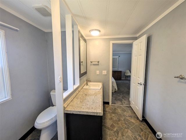 201 Union Ave SE Unit 136, Renton, WA 98059 - bathroom featuring stone finish floors, vanity, crown molding, toilet, and baseboards