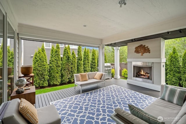 4496 Copper Ct, Gig Harbor, WA 98332 - sunroom / solarium with healthy amount of natural light and an outdoor living space with a fireplace