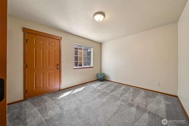 empty room with carpet flooring and baseboards