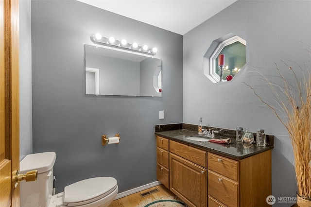 7819 Tolt River Rd NE, Carnation, WA 98014 - half bath with toilet, vanity, wood finished floors, and baseboards