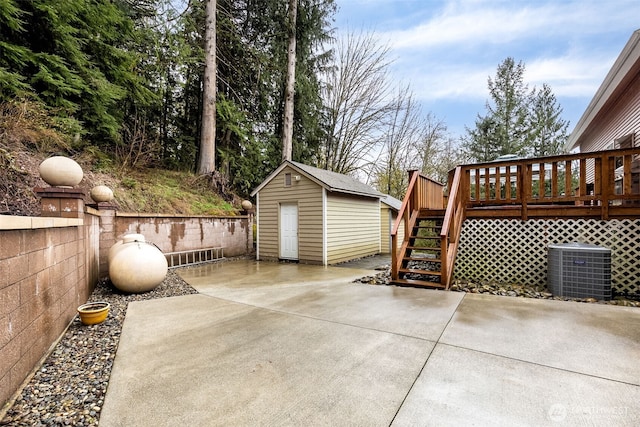 7819 Tolt River Rd NE, Carnation, WA 98014 - view of patio featuring a storage unit, stairway, central air condition unit, an outbuilding, and a deck