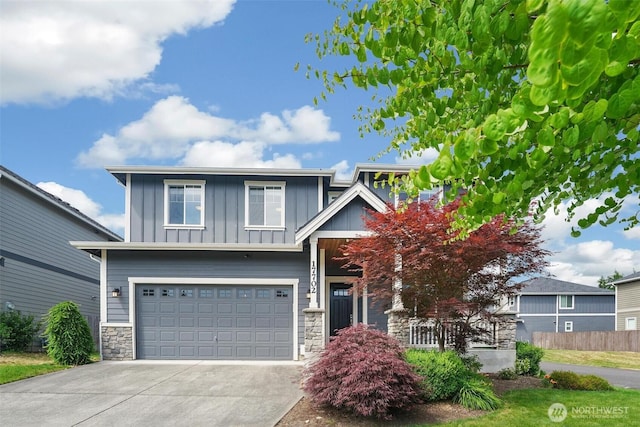 17702 SE 265th Ct, Covington, WA 98042 - craftsman-style home featuring board and batten siding, stone siding, driveway, and a garage