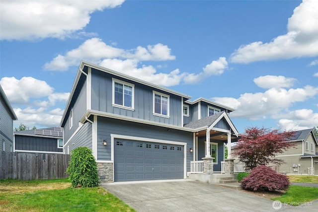 17702 SE 265th Ct, Covington, WA 98042 - view of front of house with board and batten siding, a garage, driveway, stone siding, and a porch