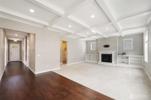 17702 SE 265th Ct, Covington, WA 98042 - unfurnished living room featuring beamed ceiling, coffered ceiling, recessed lighting, a fireplace with raised hearth, and plenty of natural light