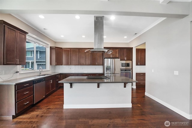 17702 SE 265th Ct, Covington, WA 98042 - kitchen with appliances with stainless steel finishes, island exhaust hood, a kitchen island, a kitchen bar, and tasteful backsplash