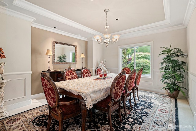 4316 Crystal Lane Loop SE, Puyallup, WA 98372 - dining room featuring a raised ceiling, a chandelier, wainscoting, a decorative wall, and ornamental molding