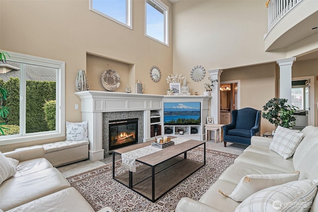4316 Crystal Lane Loop SE, Puyallup, WA 98372 - living area featuring a towering ceiling, carpet floors, a premium fireplace, and healthy amount of natural light