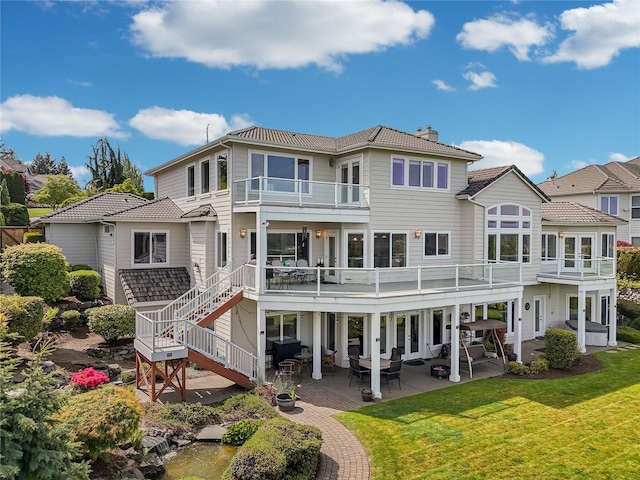 4316 Crystal Lane Loop SE, Puyallup, WA 98372 - back of property featuring a chimney, a balcony, a yard, and a patio