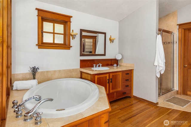 14010 SW Bates Rd, Vashon, WA 98070 - full bath with a stall shower, wood finished floors, a bath, and vanity