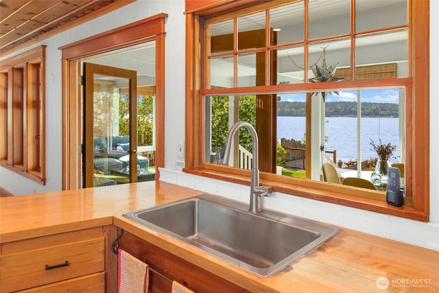 14010 SW Bates Rd, Vashon, WA 98070 - kitchen featuring a sink, a water view, healthy amount of natural light, and wood counters