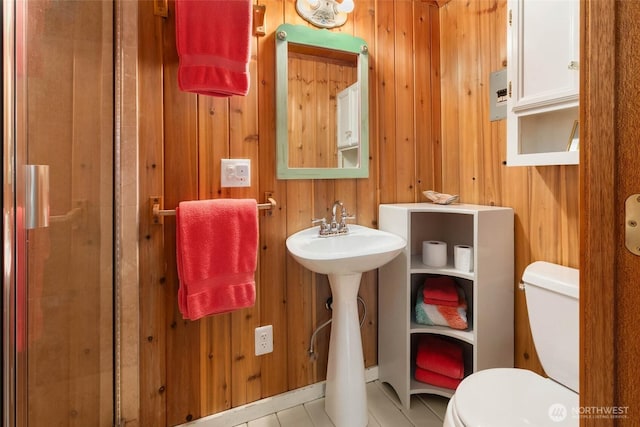 14010 SW Bates Rd, Vashon, WA 98070 - bathroom featuring toilet, wood walls, tile patterned flooring, and a sink