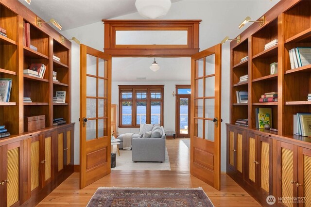 14010 SW Bates Rd, Vashon, WA 98070 - sitting room featuring french doors, light wood-type flooring, lofted ceiling, and a water view