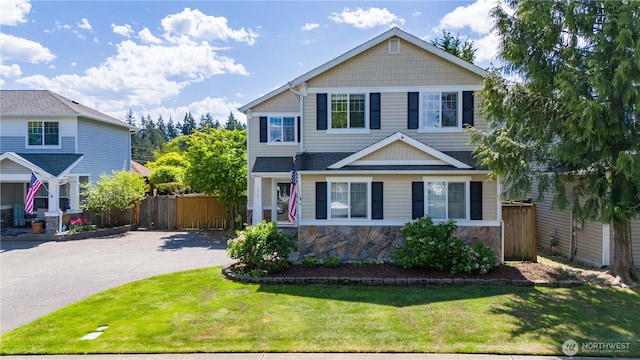 view of front of house featuring stone siding and driveway