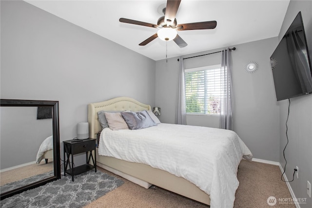 bedroom with carpet, a ceiling fan, and baseboards