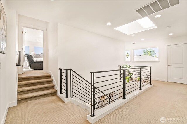 staircase with carpet, a skylight, baseboards, and recessed lighting