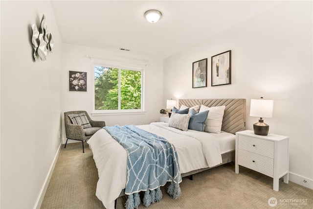 bedroom featuring baseboards and light carpet