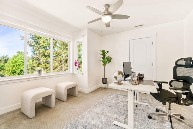 carpeted office featuring baseboards and ceiling fan