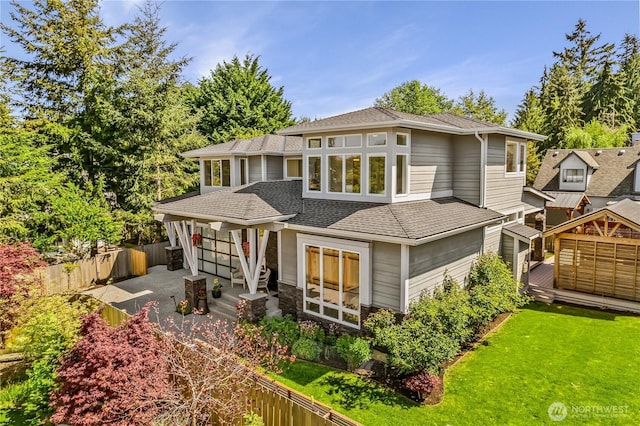 rear view of property with a shingled roof