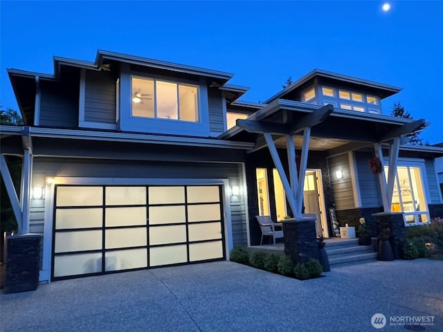 view of front of house featuring a garage, concrete driveway, a porch, and stone siding