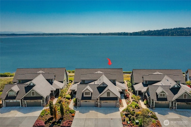 aerial perspective of suburban area with a nearby body of water