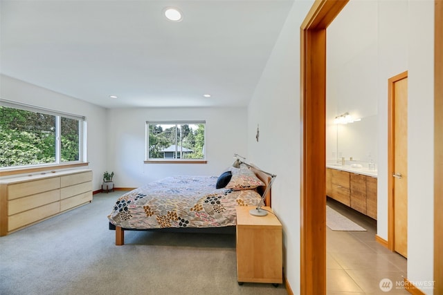 14016 30th Ave NE, Seattle, WA 98125 - carpeted bedroom with multiple windows, recessed lighting, ensuite bathroom, and baseboards