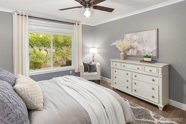 bedroom with baseboards, dark wood-style floors, a ceiling fan, and crown molding
