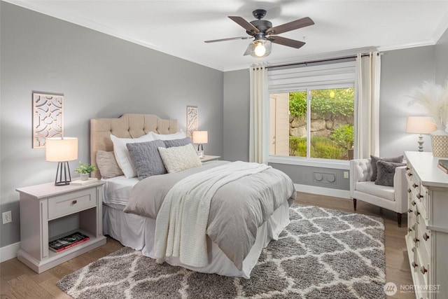 bedroom with baseboards, light wood-type flooring, ornamental molding, and ceiling fan