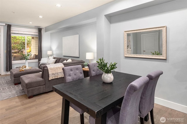 dining area with light wood-type flooring, recessed lighting, and baseboards