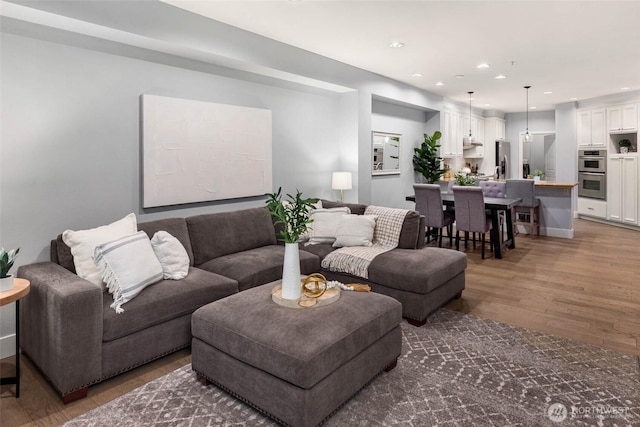 living area with wood finished floors and recessed lighting